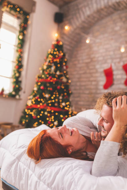 istock Couple spending Christmas morning in bed 1287870846
