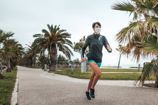 istock Woman training outdoors in the new normal 1287871801