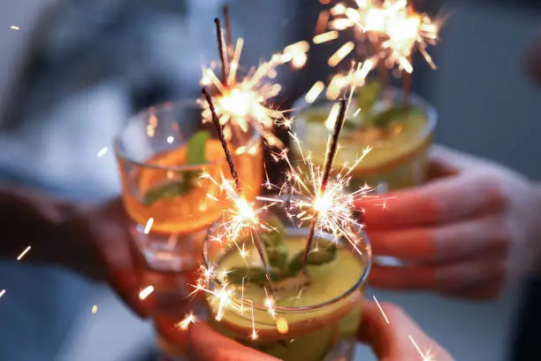 Photo of People hold glasses with fruit cocktails close-up