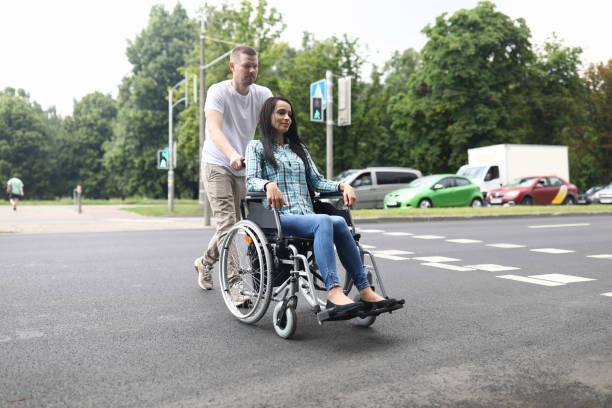 istock Husband rolls a wheelchair with a young wife 1287872719