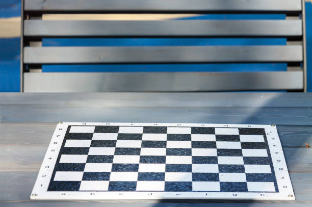 istock Empty chess board table with park bench. Outdoor activities concept 1287874215