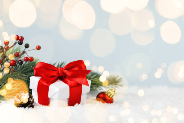 istock Christmas gift box and fir tree in a snowdrift 1287874559