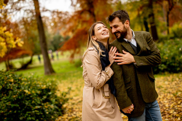 istock Young couple walking in the autumn park 1287876393