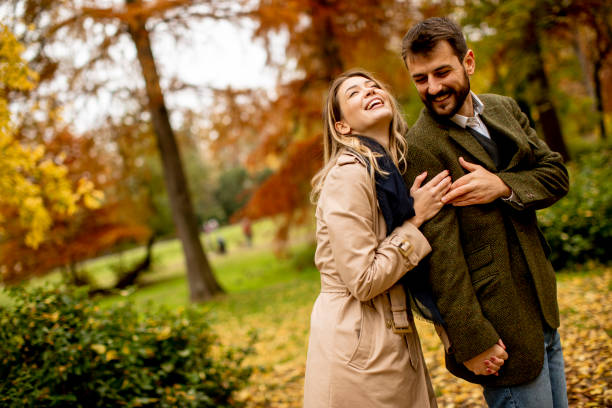 istock Young couple walking in the autumn park 1287876411