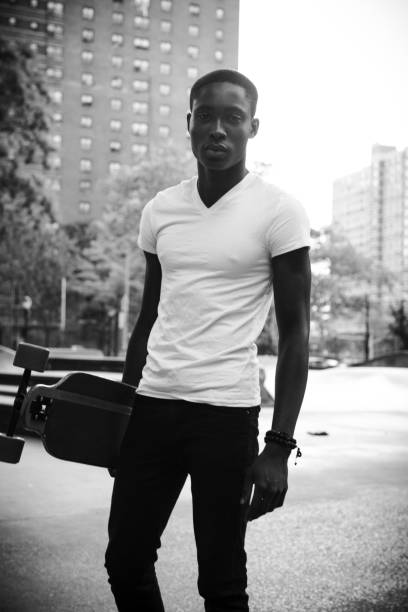 istock Young man with a longboard portrait in New York 1287878805