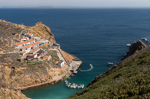 Berlenga Island, Portugal - August 28, 2019: view of the fishers village of Berlenga, with anchored boats, seen from Berlenga island, in Portugal, with Peniche coast at sight.