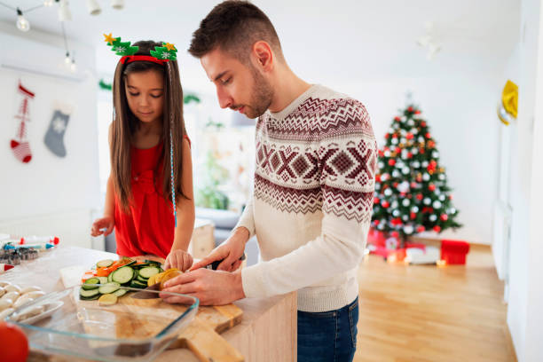 istock Young girl helping father in preparing Christmas dinner 1287880975