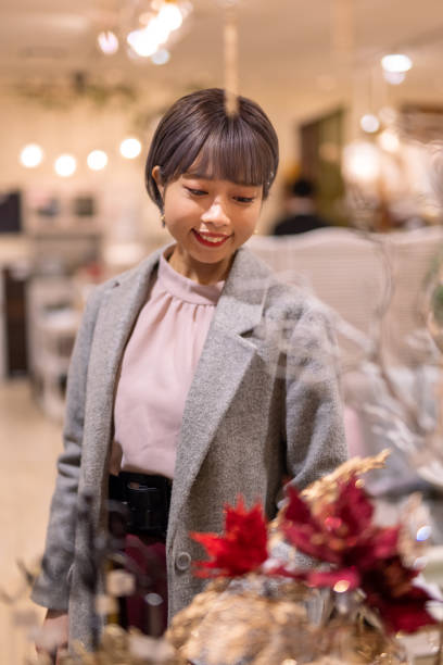 istock Young woman looking for Christmas decorations at retail store 1287881129