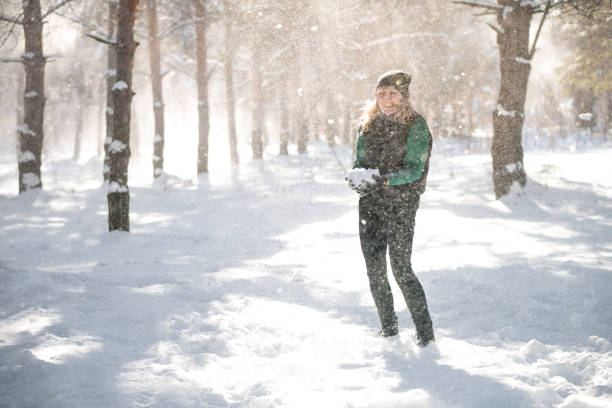 istock Woman in snowy forest in winter time. 1287882190