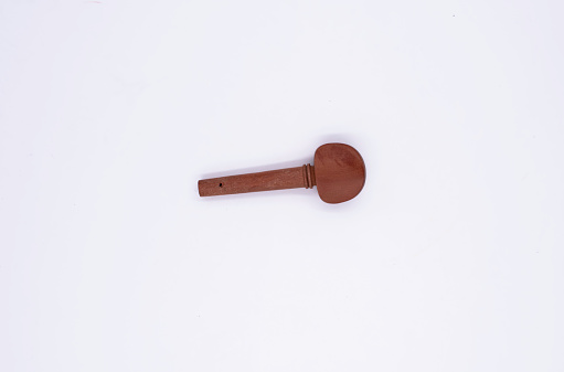 Violin tuning peg put on white background,part of acoustic violin