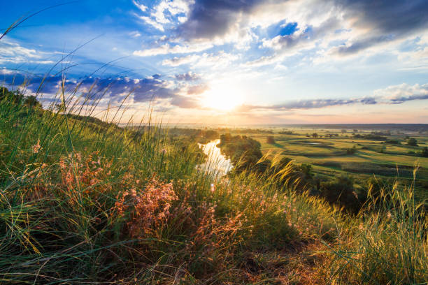 istock A beautiful valley with a river, blue sky with large clouds and bright sun. Aerial 4K UHD 1287882470
