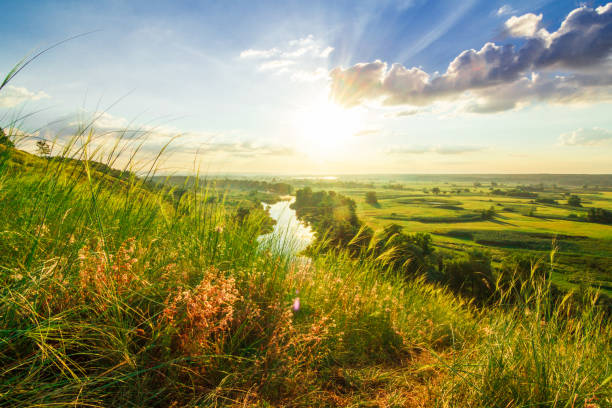 istock A beautiful valley with a river, blue sky with large clouds and bright sun. Aerial 4K UHD 1287882529