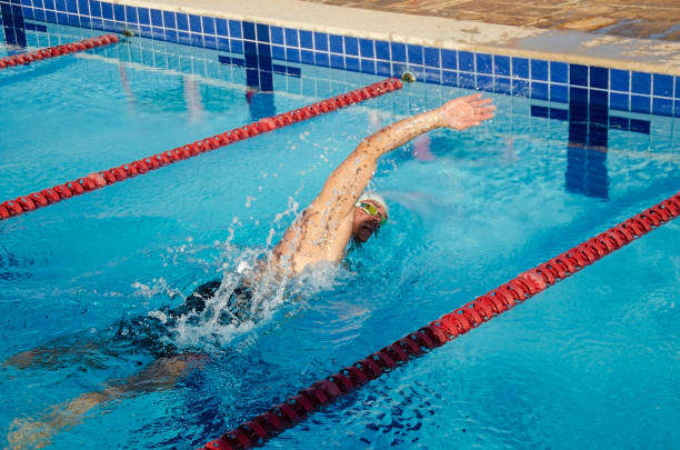 istock Man swimming in a swimming pool. 1287882961