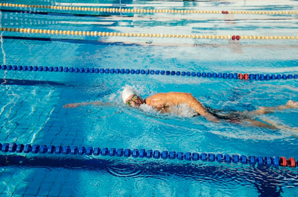 istock Man swimming in a swimming pool. 1287883130