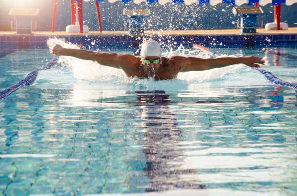 istock Man swimming in a swimming pool. 1287883237