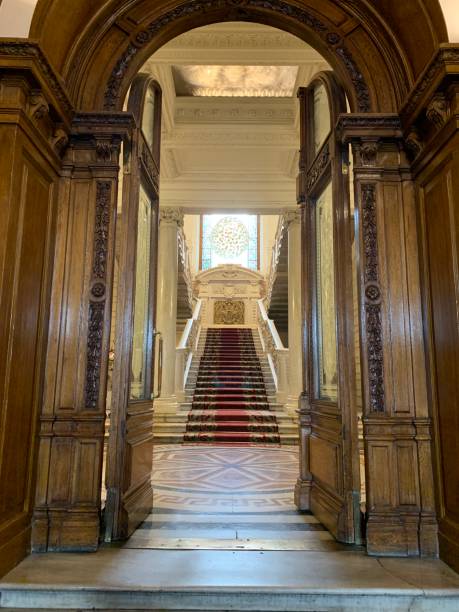 istock White marble staircase with stucco and twisted patterns, with carpet and a huge colored stained glass window 1287883252