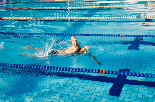 istock Man swimming in a swimming pool. 1287883303
