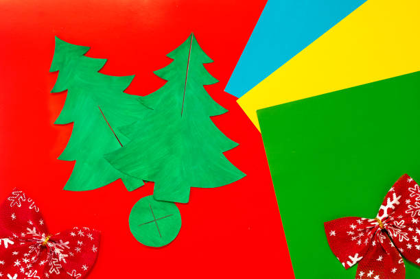 istock Christmas craft. DIY cardboard Christmas tree, step-by-step instructions on how to make a fir tree. Step 7 - Painted outlines of the Christmas trees and the base with cuts. 1287883306