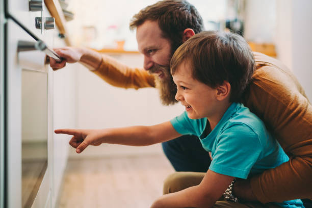 istock Father and son cooking dinner at home 1287885989