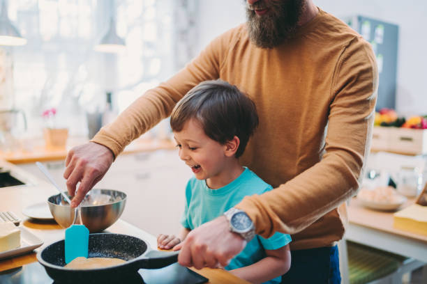istock Father and son making pancakes at home 1287886215