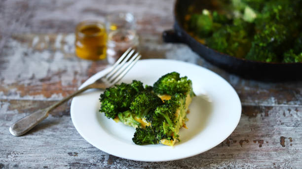 Slice of broccoli frittata on a white plate. stock photo