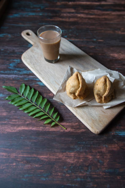 istock Close up view of Indian snack samosa and tea 1287894093