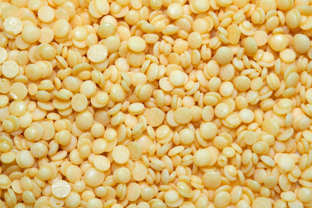 Wax beans for hair removal. Pearl wax for depilation woman legs or bikini areas. Allergen free painless yellow beads. Epilation and brazilian waxing for face, eyebrow or chest at home.