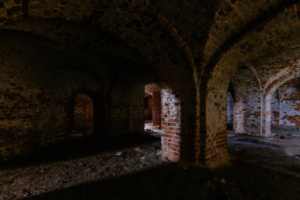 istock Dark and creepy vaulted red brick dungeon 1287902928