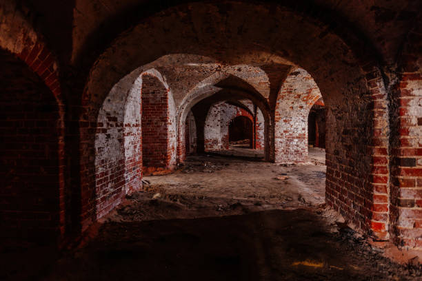 istock Dark and creepy vaulted red brick dungeon 1287902946