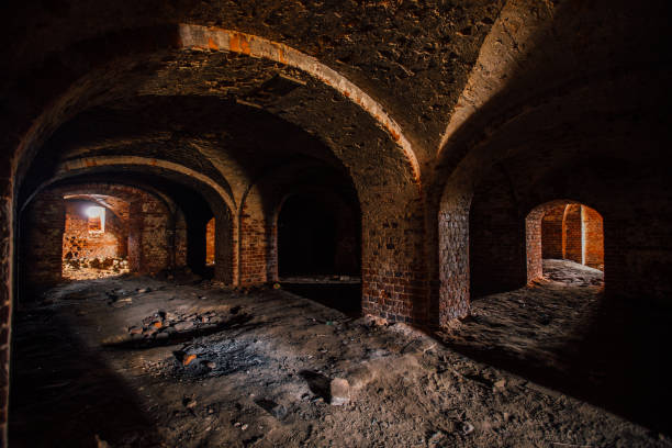 istock Dark and creepy vaulted red brick dungeon 1287902948