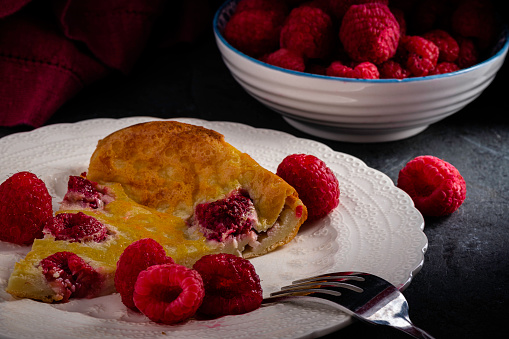 Raspberry clafoutis - Traditional French dessert made with fruit baked into an eggy batter