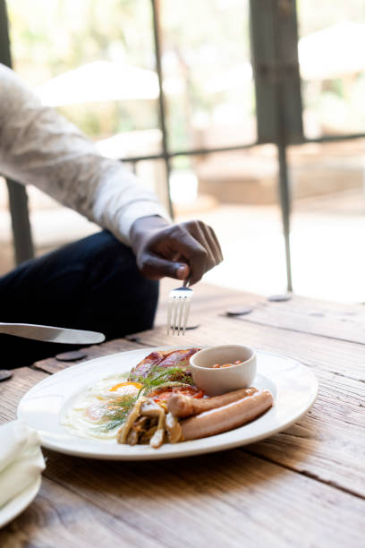 istock African male getting ready to eat breakfast in restaurant 1287904966