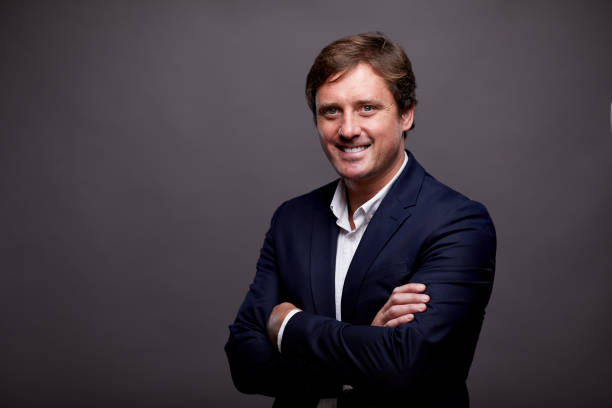 istock A business person smiling at camera on a plain background. 1287906591