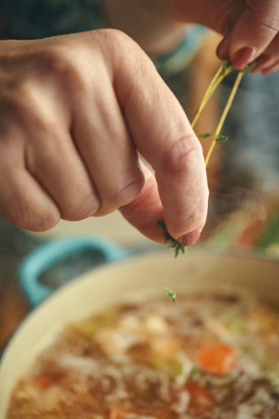 istock Preparing Chicken Noodles Soup with Fresh Vegetables 1287906983