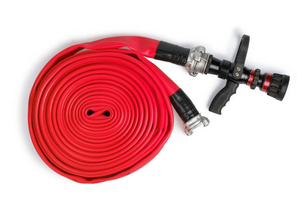 Red rolled firefighter hose isolated on the white background. Red rolled firefighter hose isolated on the white background. Flat Lay, top view fire hose stock pictures, royalty-free photos & images