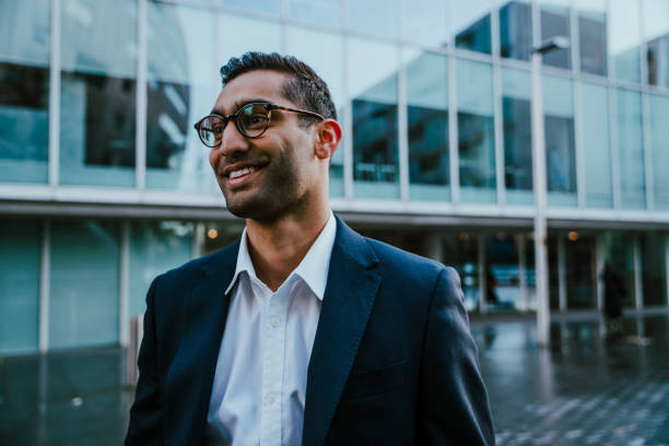 istock Portrait businessman smiling standing outside banking office before work shift 1287907345