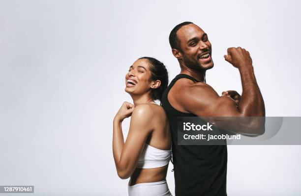 Cheerful Fit Couple On White Background Stock Photo - Download Image Now - Exercising, Healthy Lifestyle, Gym