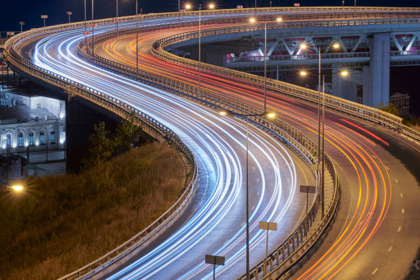 Highway at night lights Highway at night lights. Fast car light path, trails and streaks on interchange bridge road. Night light painting stripes. Long exposure photography long shutter speed stock pictures, royalty-free photos & images