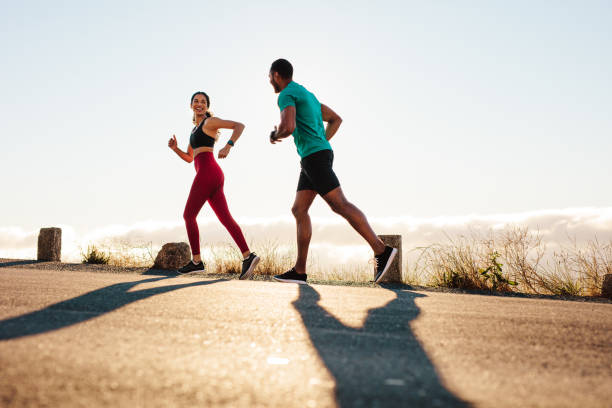 istock Fitness couple running on road 1287910687