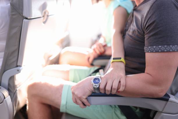 istock Woman hand squeezes man hand in fear on plane. 1287911044