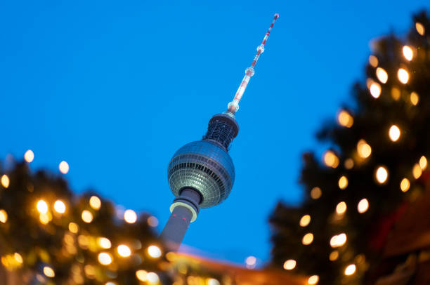 A tower that gives off a green light at night taken with the landscape technique
