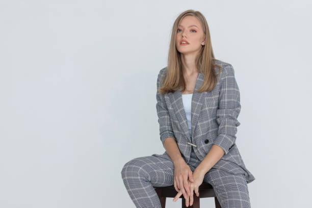 istock blonde woman wearing gray checkered suit 1287915689