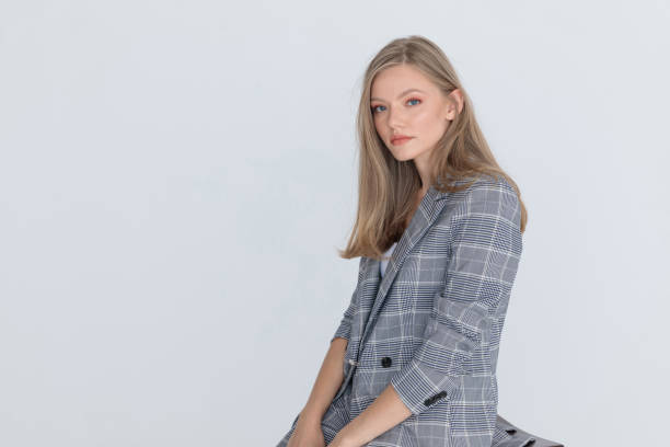 istock timid young woman sitting on light gray background 1287915921