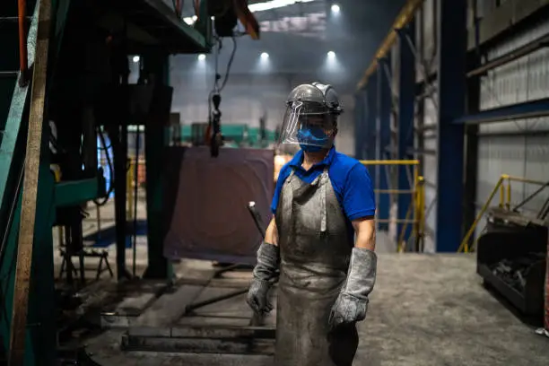 Portrait of a worker wearing welding helmet in a metal industry