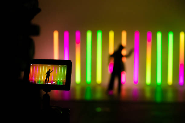 istock Camcorder display and blurred frame with young woman dancing street dance hip hop in a studio with neon lighting tube on a colorful background 1287917962