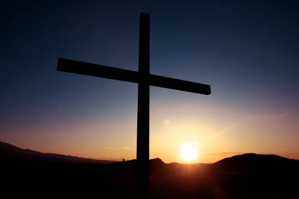 istock cross  in mountain at the sunset 1287918247