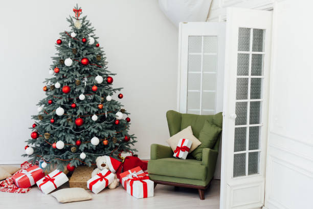 istock Beautiful holdiay decorated room with Christmas tree with presents under it 1287918348