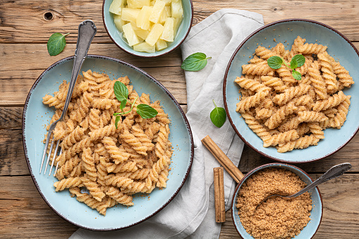 Fusilli pasta with sweet roasted semolina and cinnamon, served with pineapple pieces