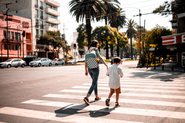 istock Mother and son crossing street 1287919965