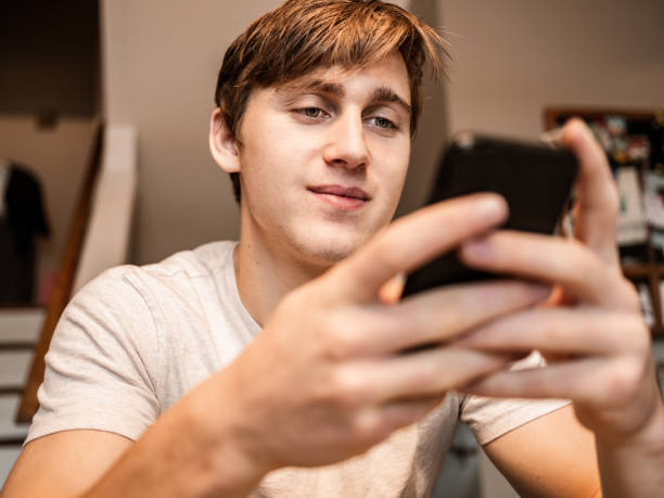 istock Young man gaming at home 1287921469